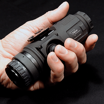 Trijicon IR-Patrol thermal monocular shown fitting perfectly in the palm of a hand.