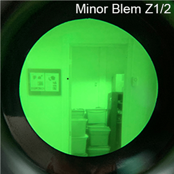 Looking through the lens of a AN/PVS-14A GEN III unit with a minor blemish.