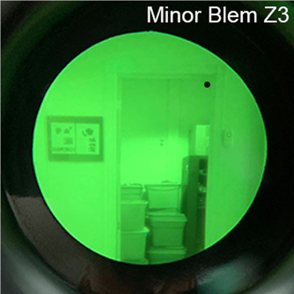 Looking through the lens of a AN/PVS-14A GEN III unit with a minor blemish.