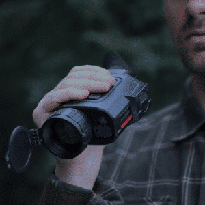 Man shown holding a InfiRay Outdoor Finder FH35R V2 thermal monocular.